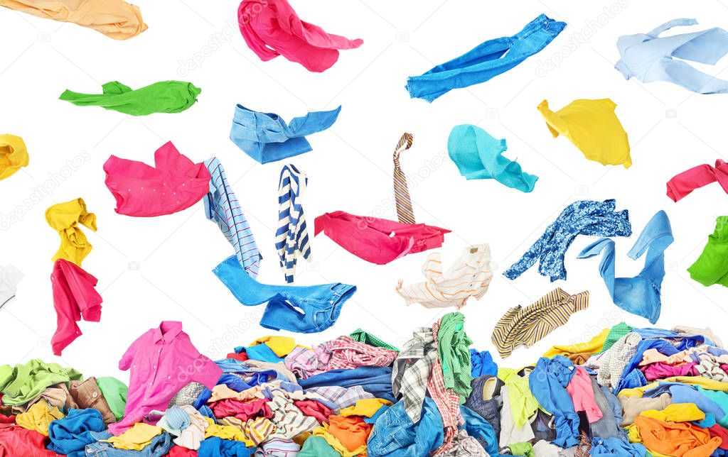 Separate clothing falling at the big pile of clothes on a white 