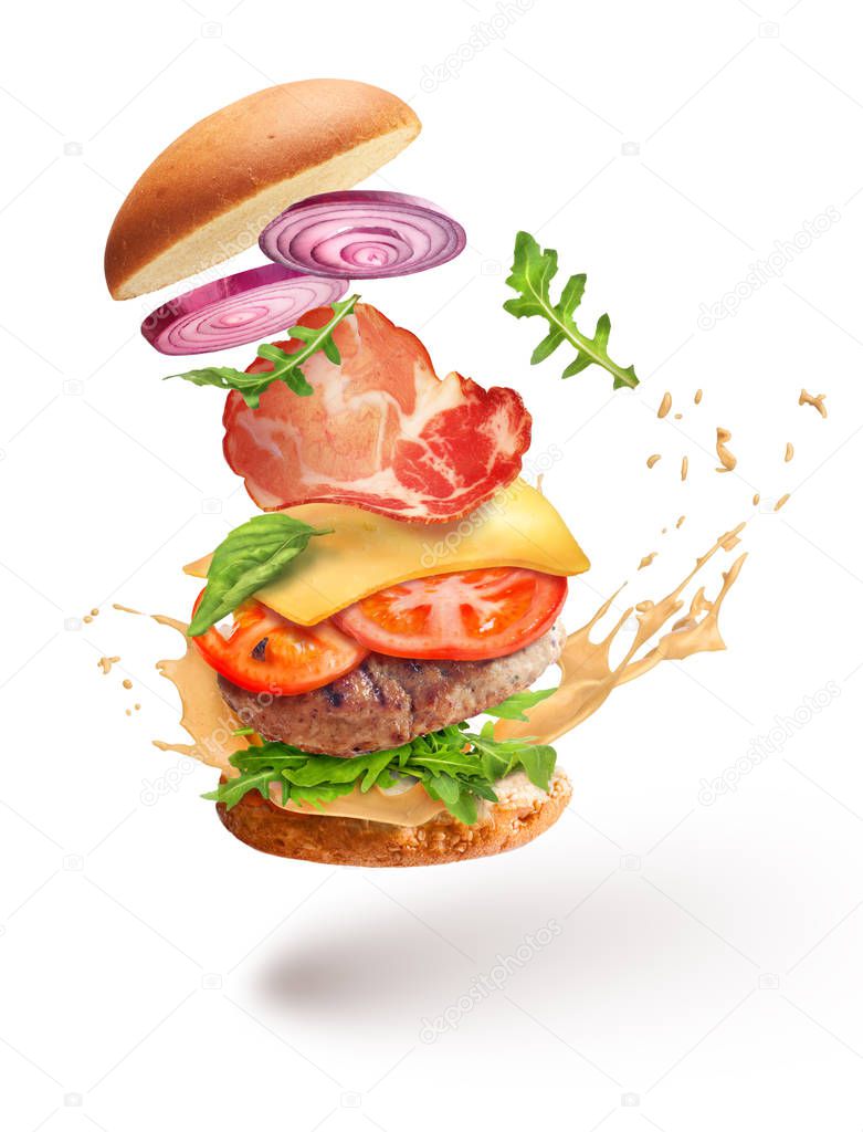 hamburger with mustard in flight on a white background