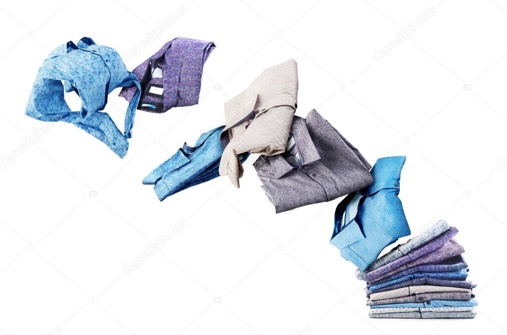 Shirts fly from a pile isolated on a white background