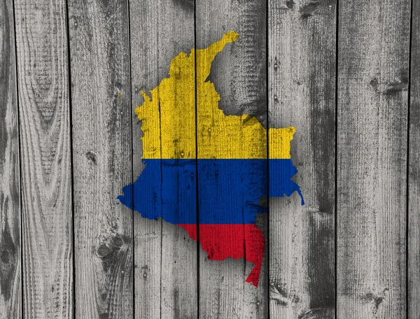 Harita ve yıpranmış ahşap üzerine Kolombiya Cumhuriyeti bayrağı — Stok fotoğraf