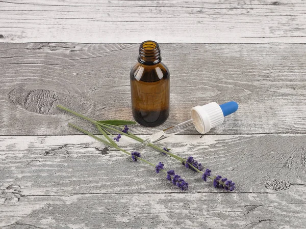 Lavender and essence on weathered wood — Stock Photo, Image