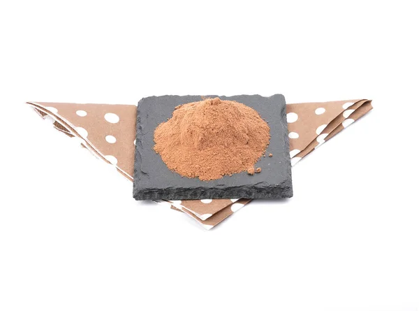 Cocoa powder on shale and white — Stock Photo, Image