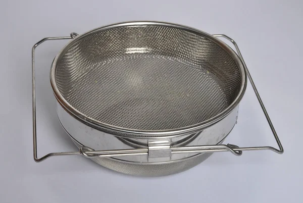 Honey sieve stainless steel on gray — Stock Photo, Image