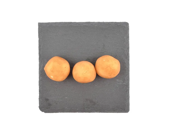 Marzipan potatoes on shale board — Stock Photo, Image