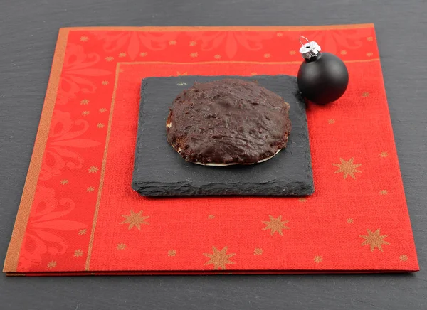 German Lebkuchen with christmas napkin on slate — Stock Photo, Image