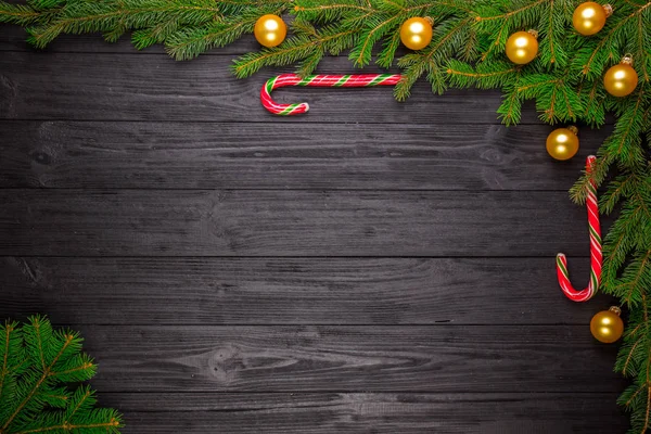 Christmas fir tree on black wooden background — Stock Photo, Image