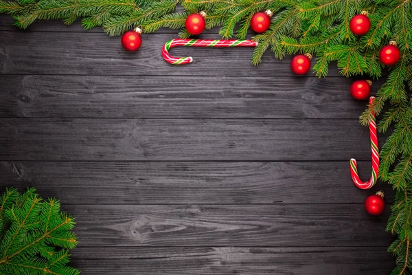 Christmas fir tree on black wooden background — Stock Photo, Image