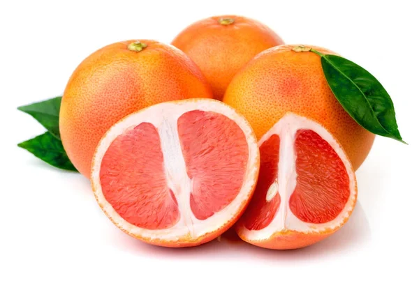 Pink grapefruits with green leaves isolated on white — Stock Photo, Image
