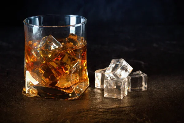 Glass of whiskey with ice cubes Royalty Free Stock Images