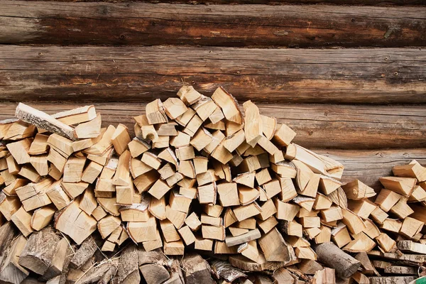 Firewood near the wall of house Stock Image