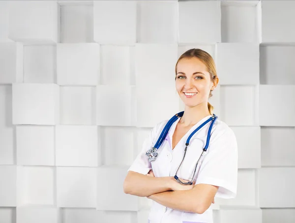 Smiling woman doctor in uniform looking at camera — Stock Photo, Image
