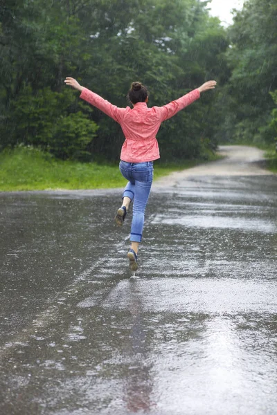 Rain city happy girl jumping in the puddle — Stock Photo, Image
