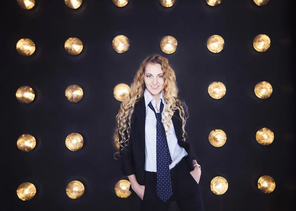 Woman wearing classical suit over golden shining background — Stock Photo, Image