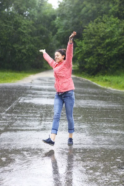 Rain city happy girl jumping in the puddle — Stock Photo, Image