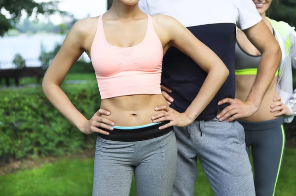 Young friends exercising and stretching muscles before sport act — Stock Photo, Image