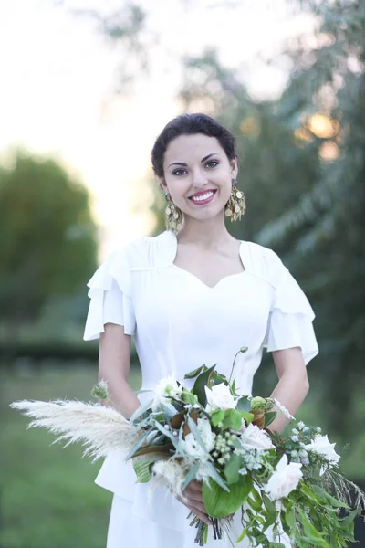 Portrait young bride with brunette hair in white wedding dress a — Stock Photo, Image