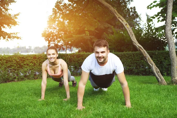 Happy sporty young couple training outdoors — Stock Photo, Image