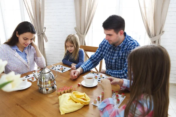Happy young family plaing board game — Stock Photo, Image