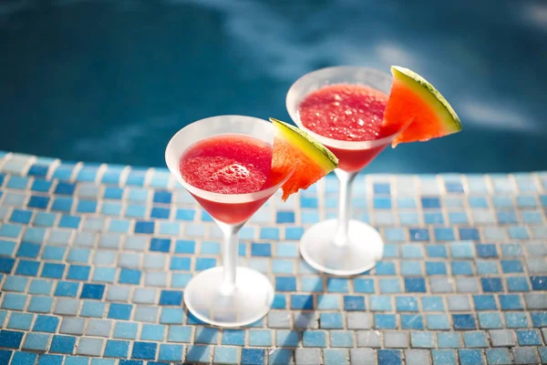 Glasses of watermelon cocktail near the pool — Stock Photo, Image