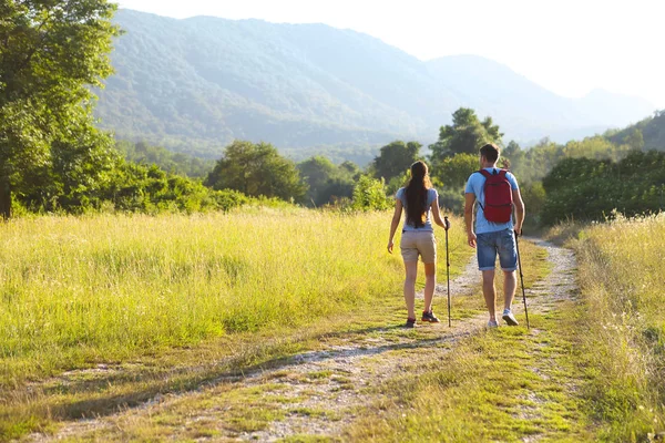 Kadın ve erkek sırt çantası ile dağlarda hiking — Stok fotoğraf