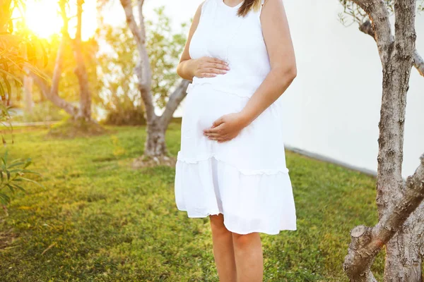 Pregnant woman touching her belly with hands — Stock Photo, Image