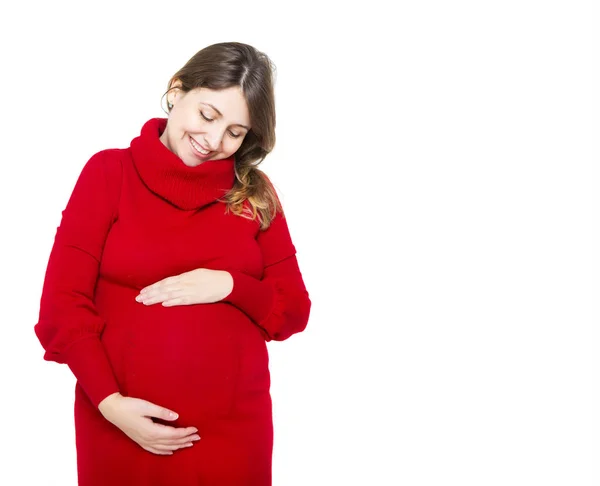 Szczęśliwy w ciąży kobieta w czerwonej sukience dotykając jej brzuch — Zdjęcie stockowe