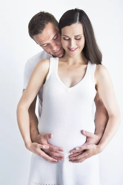 Young man and pretty pregnant woman hugging together — Stock Photo, Image