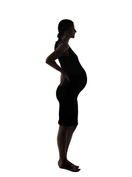 Silueta mladé docela těhotné ženy na bílém pozadí — Stock fotografie
