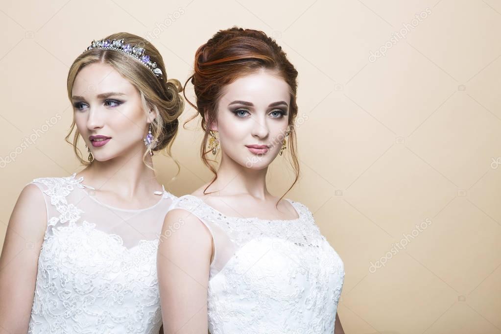 Two young caucasian pretty brides in studio