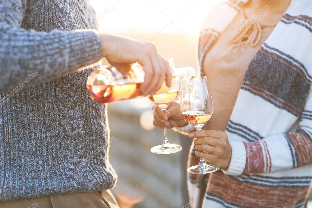 Man and woman with wineglasses outdoors