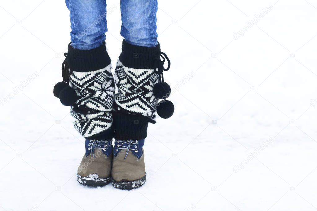 Legs of woman walking in winter park with copy space area for a 