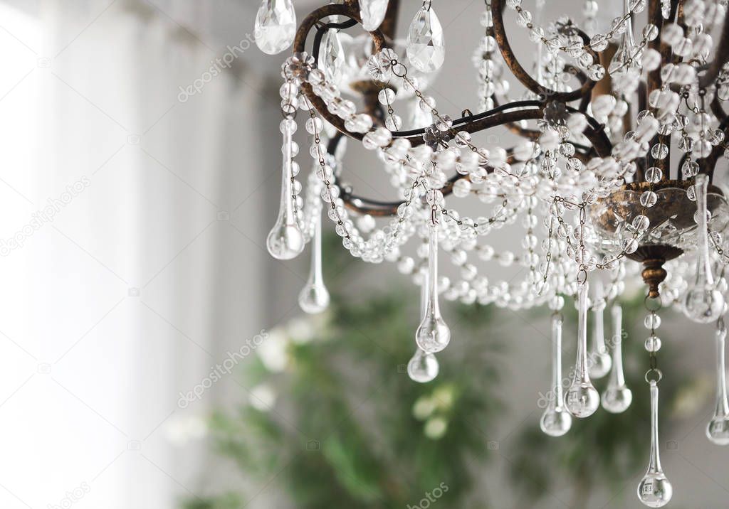 Contemporary crystal chandelier in room interior
