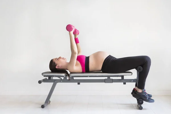 One young pregnant woman doing fitness exercises — Stock Photo, Image