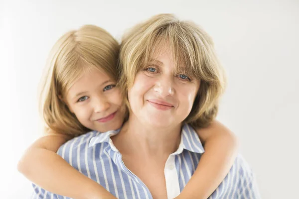 Mature woman embrace with young girl — Stock Photo, Image