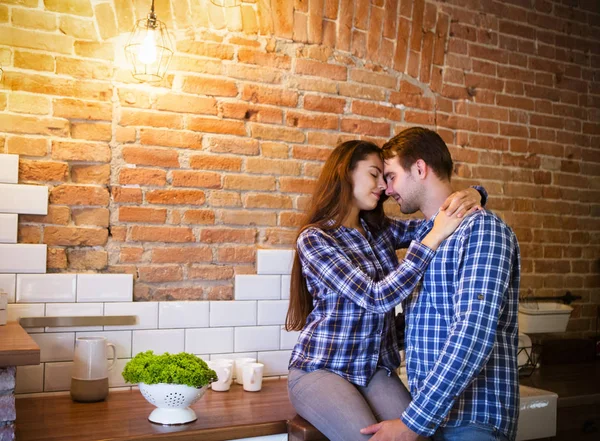 Young couple hugging and kissing at kitchen — Stock Photo, Image