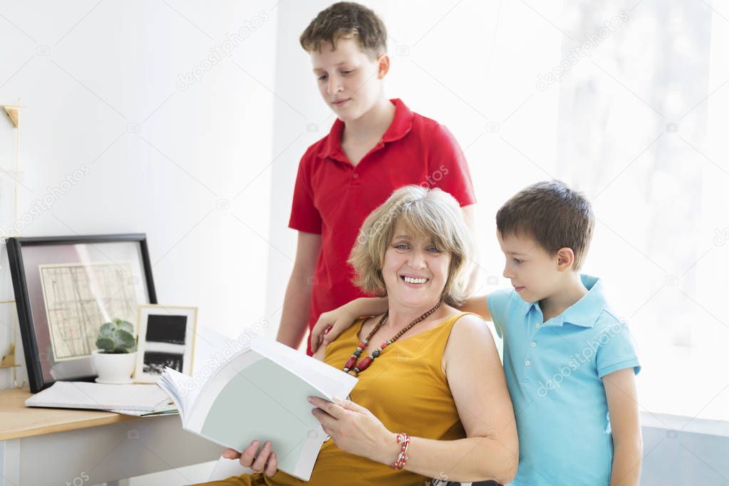 Mid-age woman with two boys indoor