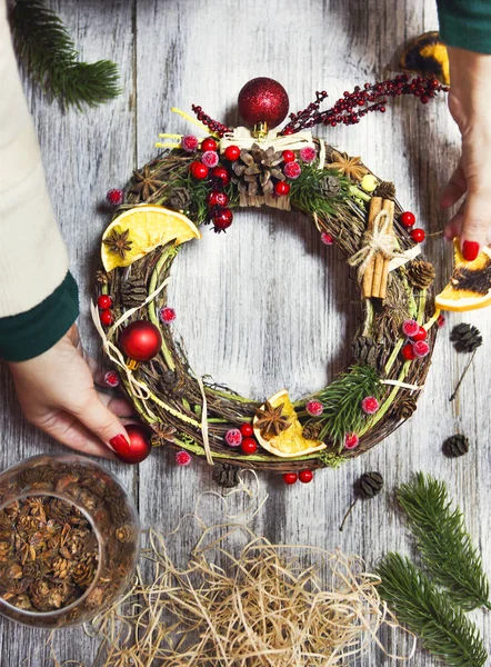 Christmas wreath in young womans hands — Stock Photo, Image