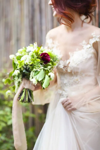 Young pretty bride with bouquet — Stock Photo, Image