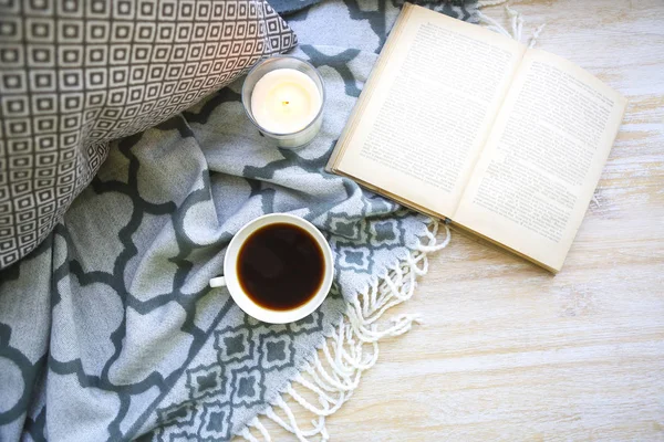 Cup of coffee, candle and book on the floor — Stock Photo, Image