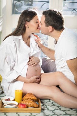 Hamile kadın ve man w yakınındaki portakal suyu ile Kahvaltı