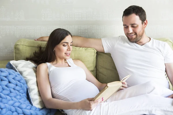 Pregnant woman and young man together indoors — Stock Photo, Image