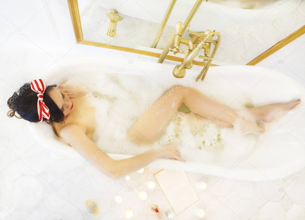 Attractive girl relaxing in the bath 