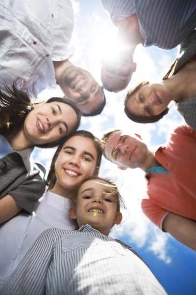 Group of happy smiling friends against blue sky — Stock Photo, Image