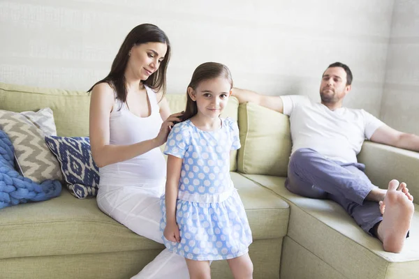 Adorable young pregnant family in living room. — Stock Photo, Image