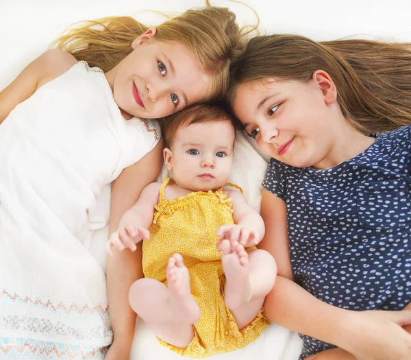 Trzy słodkie dziewczyny na łóżku — Zdjęcie stockowe
