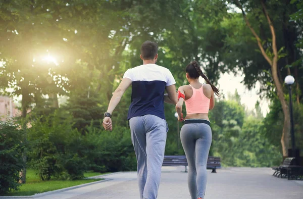 Couple jogging outside, runners training outdoors working out in — Stock Photo, Image