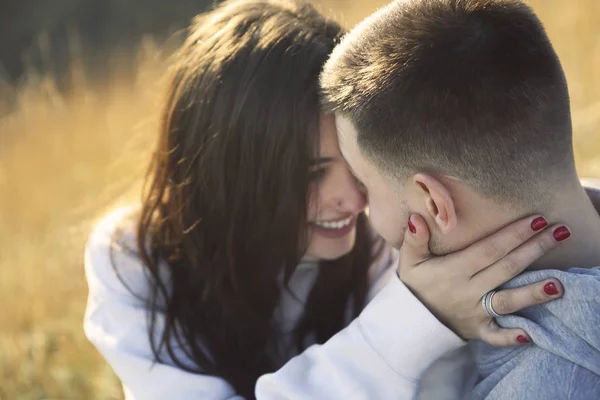 Romantic couple dressed in cozy sweaters together near the light — Stock Photo, Image