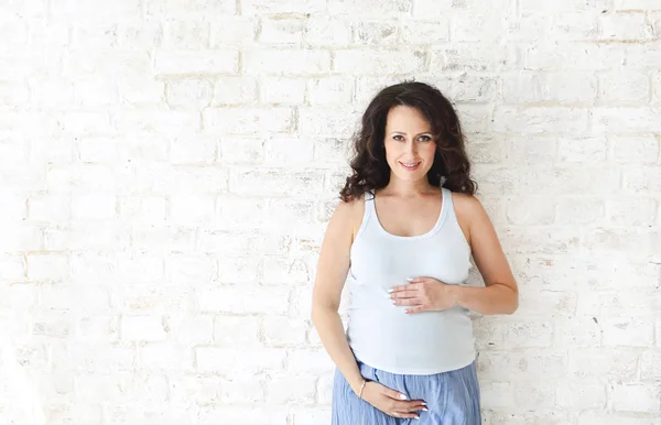 Pregnant woman touching her belly with hands — Stock Photo, Image