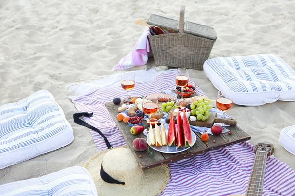 Picnic on the beach at sunset in the style of boho