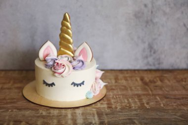 Beautiful bright cake in the form of a unicorn with cream colore